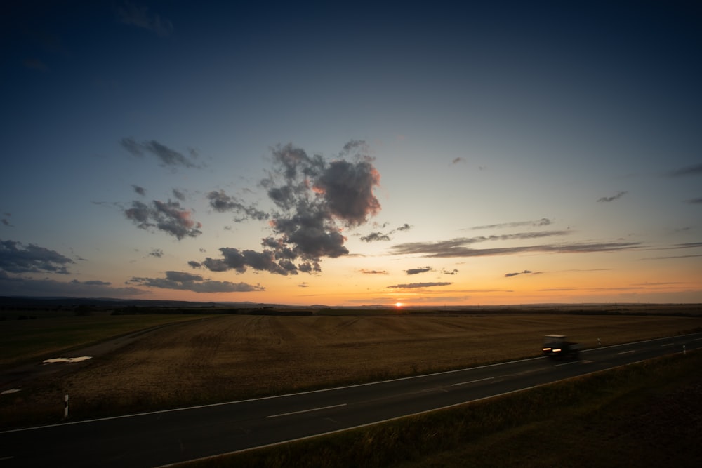 gray and yellow road at a desert at sunset