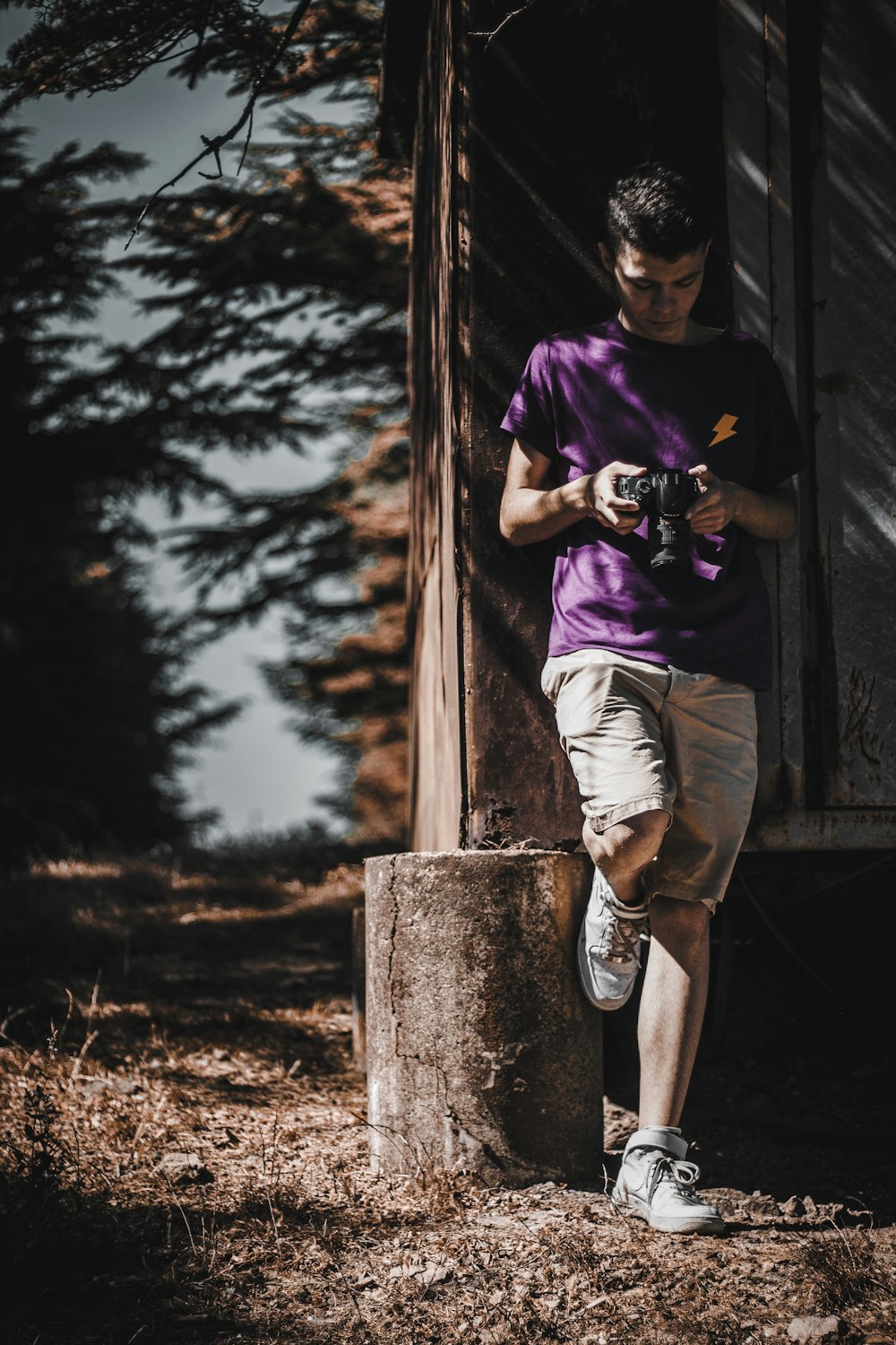 man standing beside tree