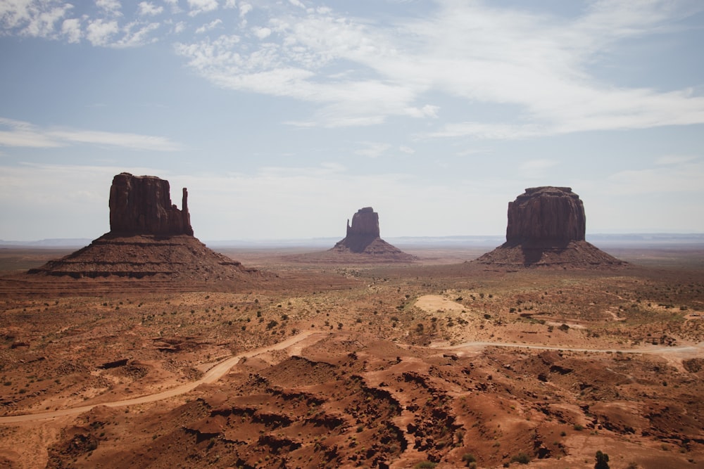 three brown buttes in desert