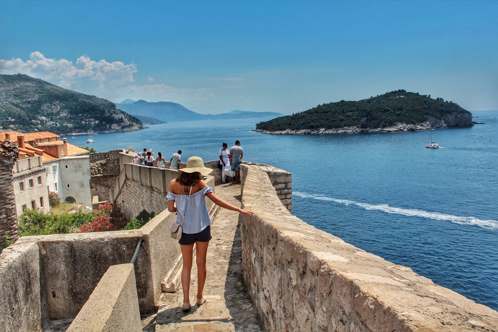 people walking on concrete pathway