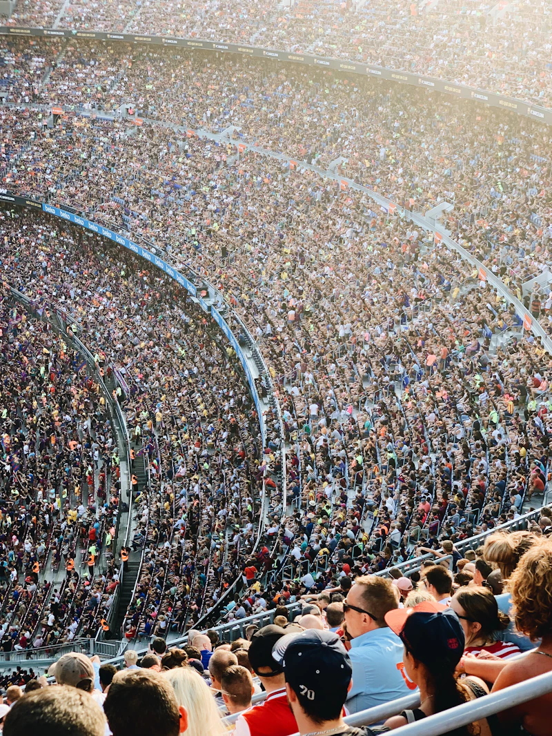 Dense rows of supporters packing a stadium terrace