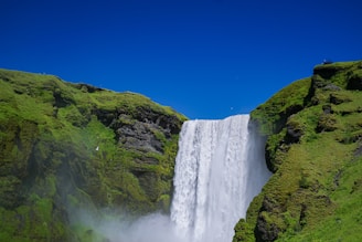 A breathtaking waterfall surrounded by greenery.