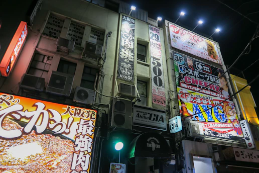 Vibrant outdoor signage mounted on a busy urban storefront at sunset
