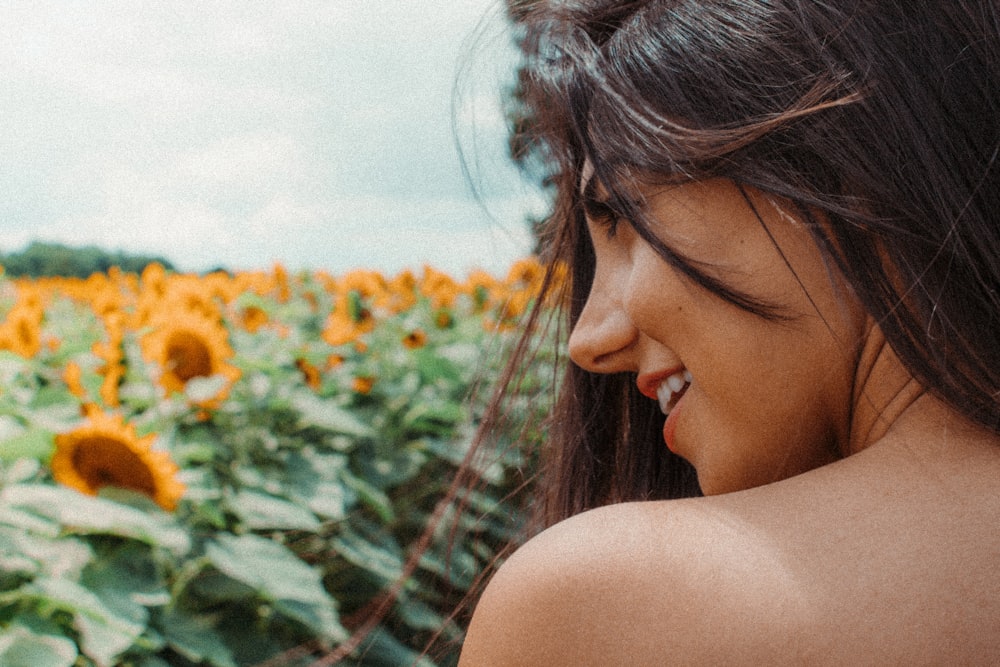 a woman standing in a field of sunflowers