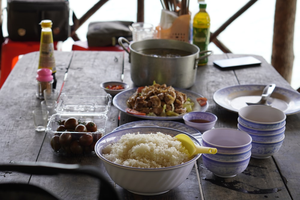 bowl of rice beside fruits and viand