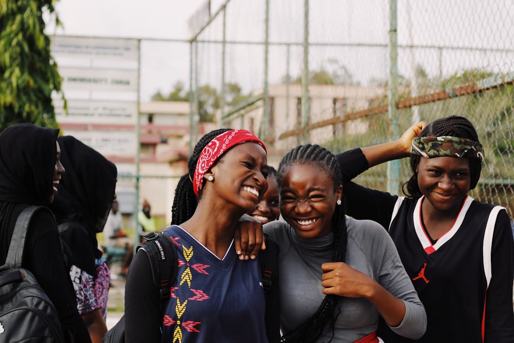 three women smiling close-up photography