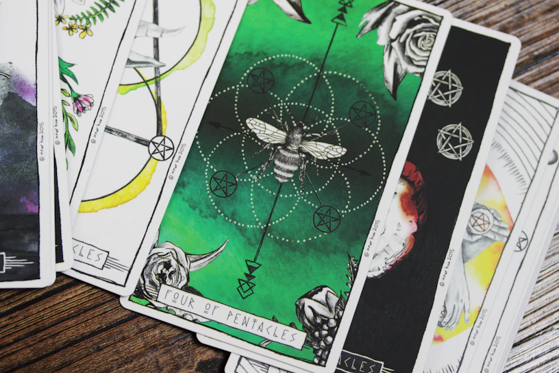 Close-up of the Ace of Pentacles tarot card featuring a radiant golden coin held by a hand emerging from a cloud.