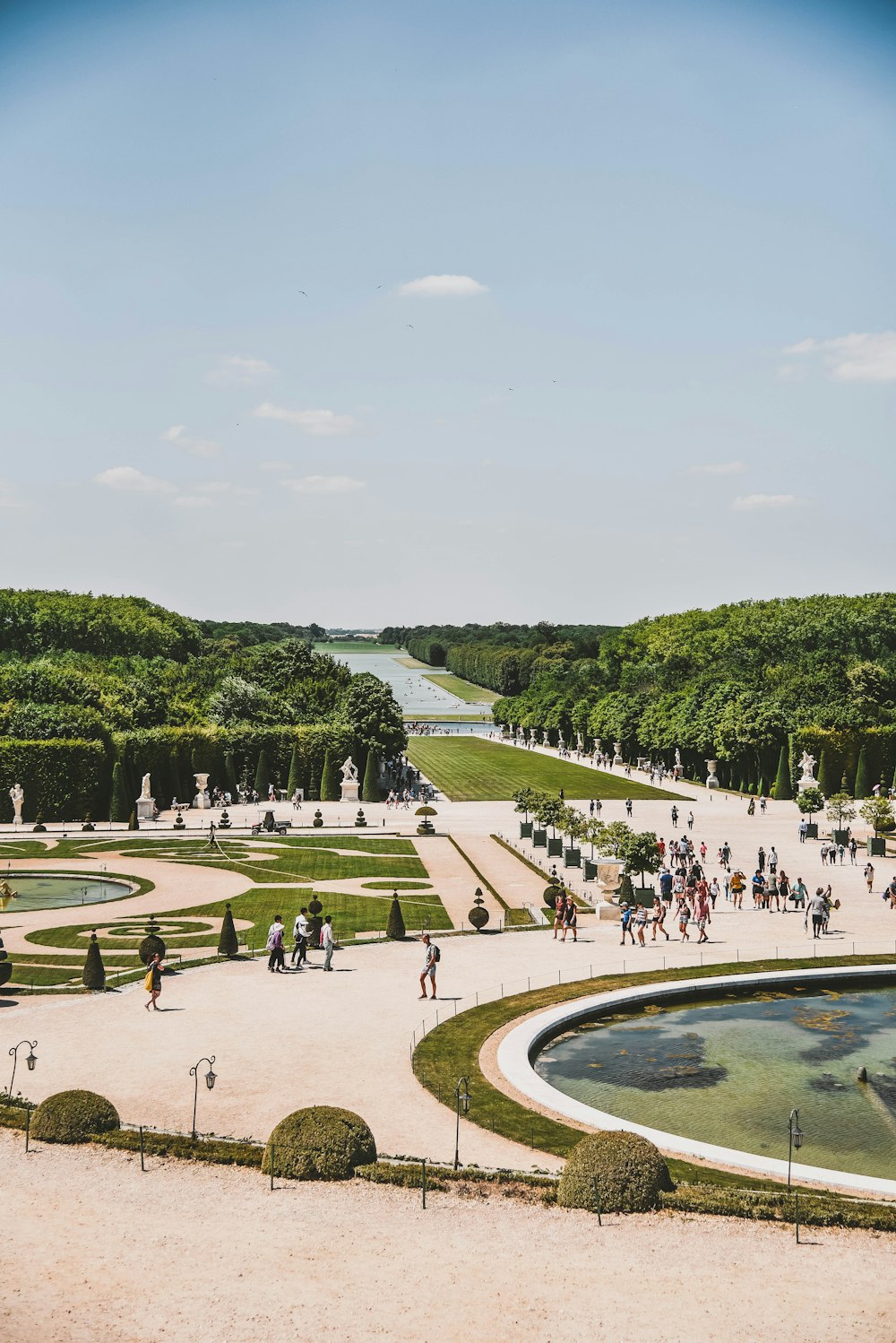 people standing beside fountain during daytime