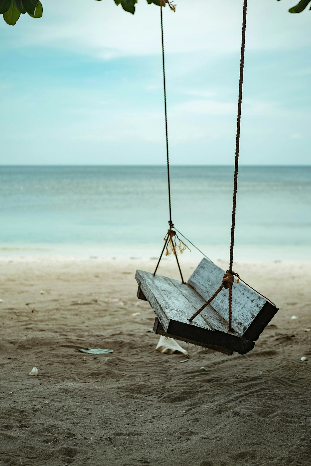 black wooden swing bench close-up photography