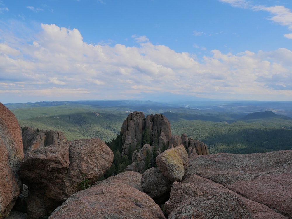 brown rock formation under white and blue sky at daytime