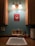 A plumber fixing a sink with tools in a well-lit kitchen.