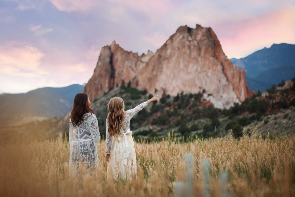 women on brown field