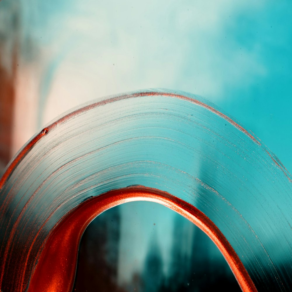 a close up of a metal object with a sky background