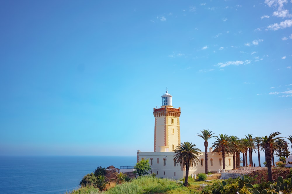 white lighthouse tower near ocean
