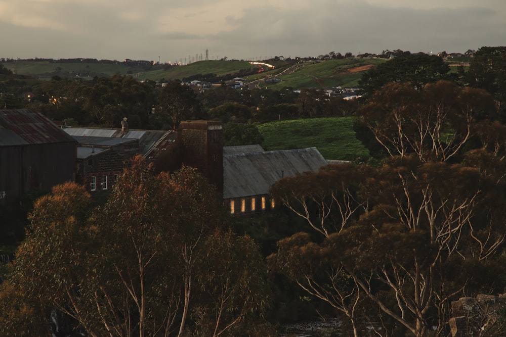 aerial view of building near trees under clouded sky