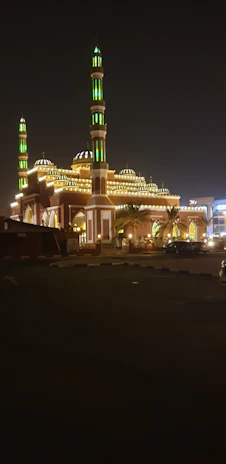The majestic Masjid Nabawi illuminated at night, highlighting its green dome.