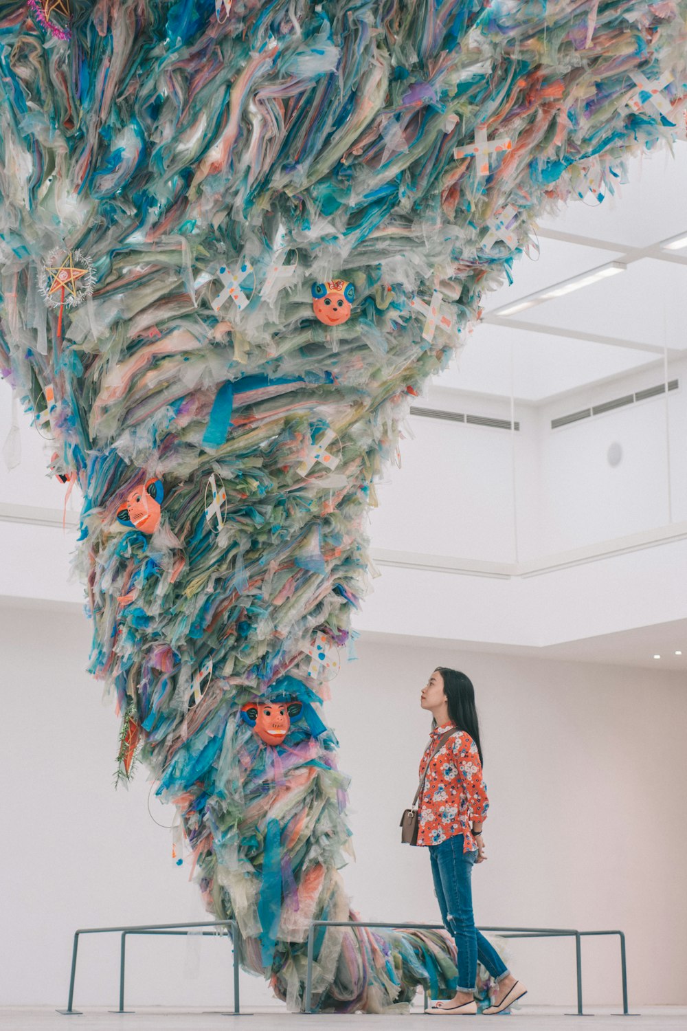 girl standing beside tornado artwork