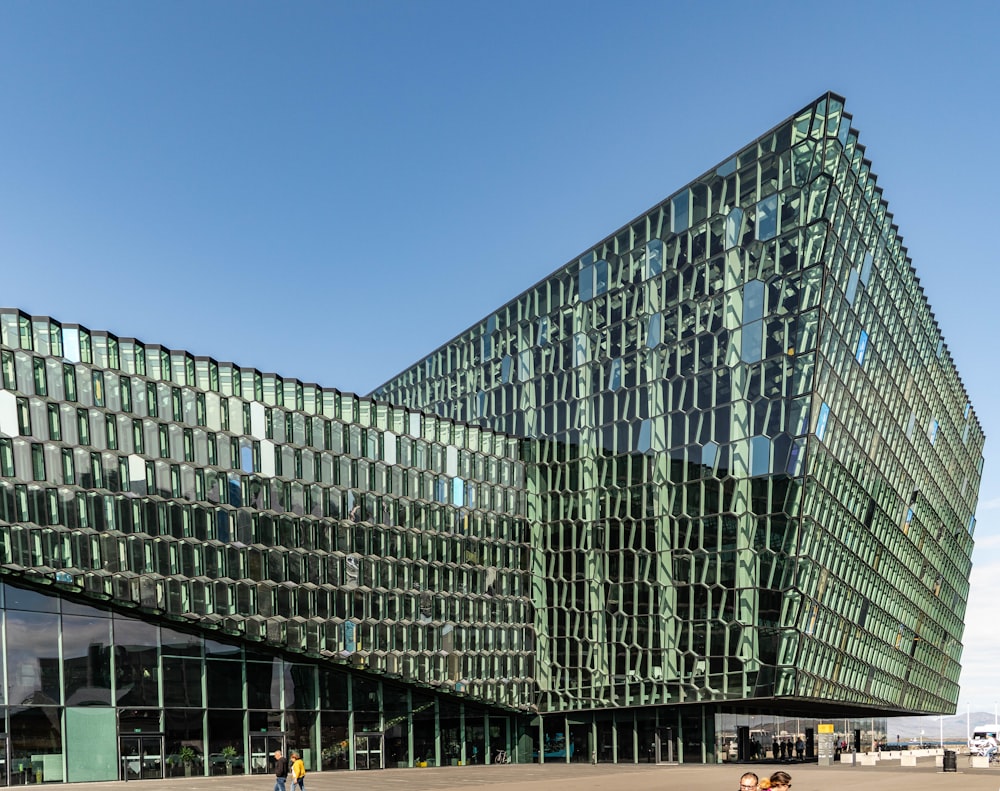 people walking outside building under blue sky