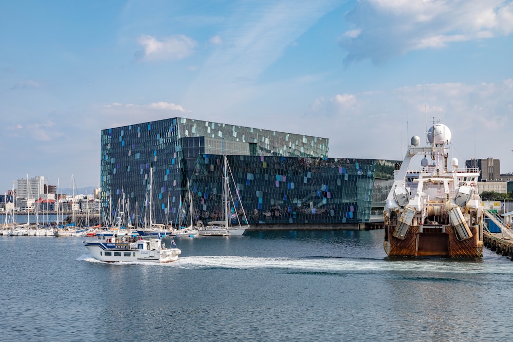 white and brown boat beside building at daytime