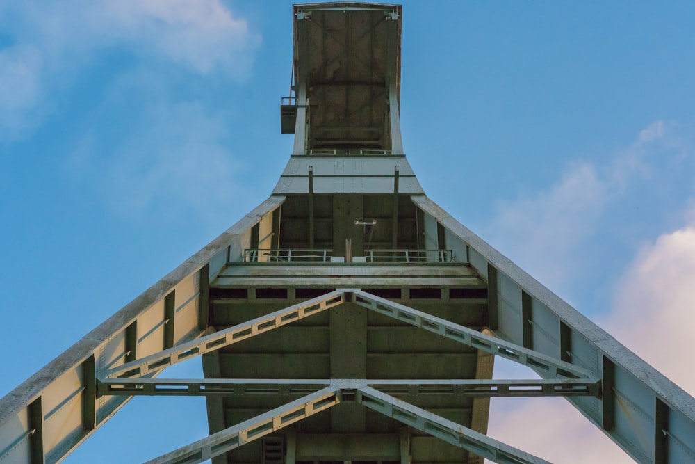low-angle photography of steel structure under cloudy sky