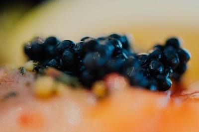 A close-up of caviar served on a mother-of-pearl spoon, showcasing its rich texture.
