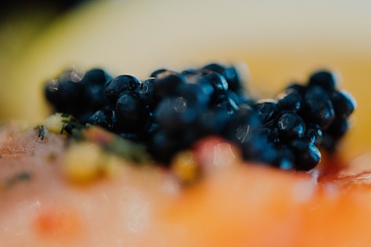 A close-up of caviar pearls glistening on a fine dining plate.