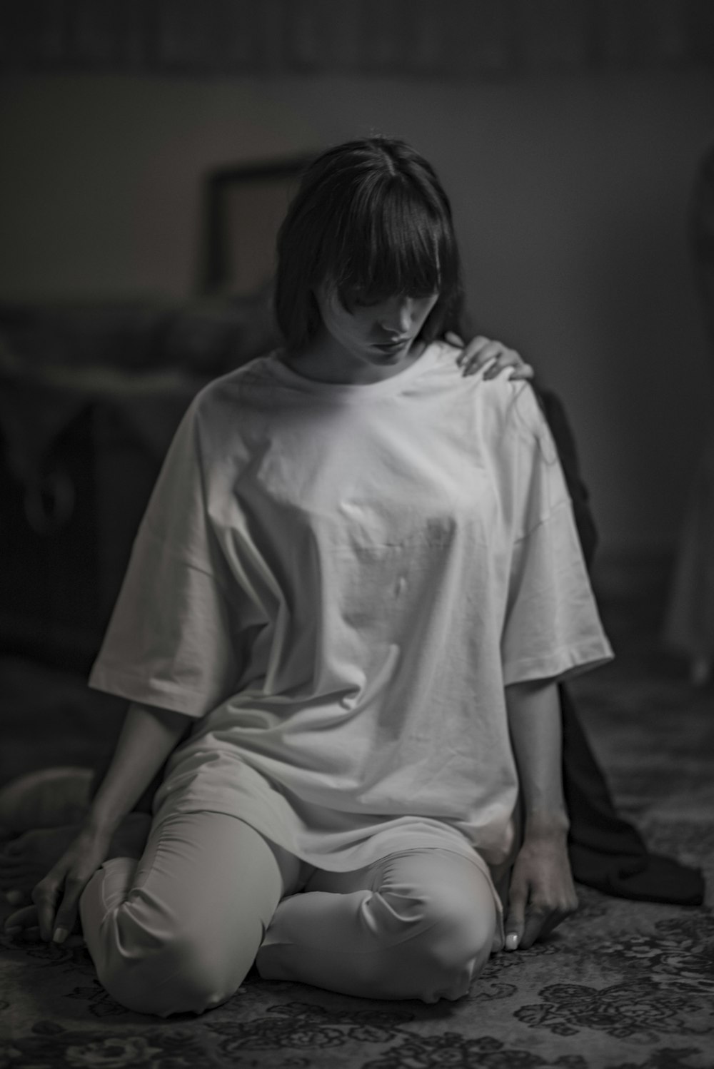 gray-scale photo of woman wearing crew-neck t-shirt