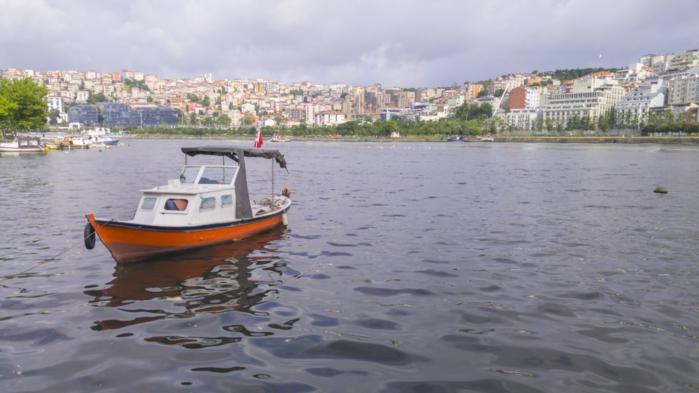boat on body of water near city