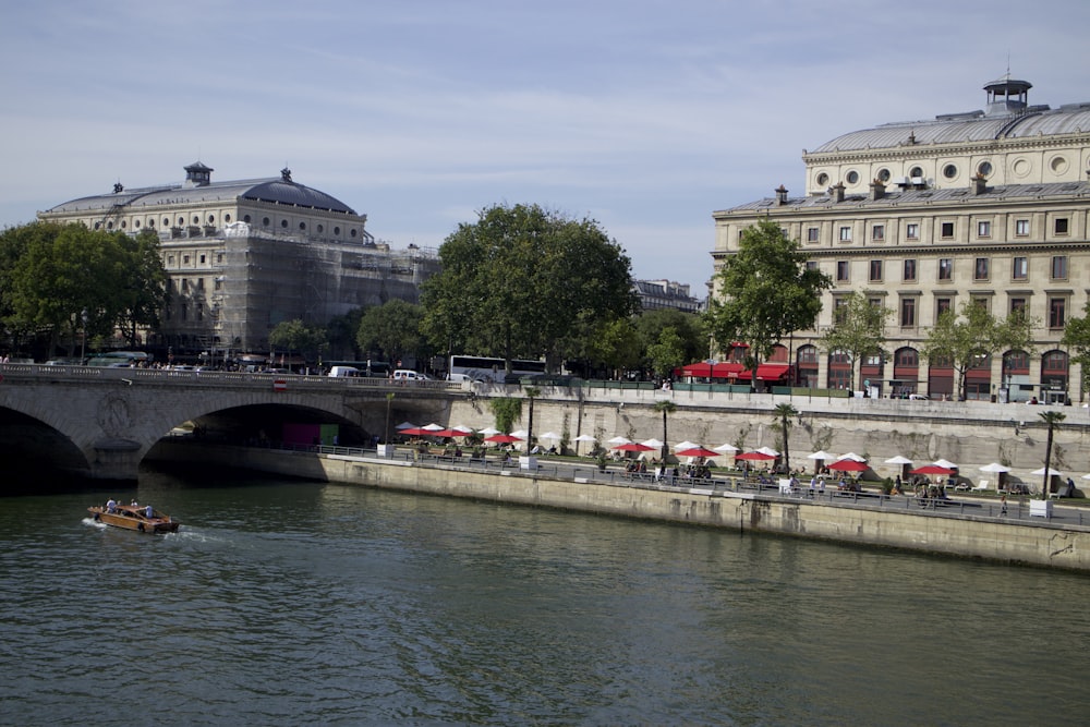 people on bridge over river during daytime