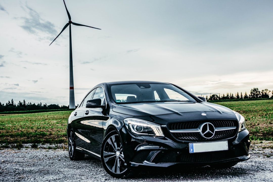 black Mercedes-Benz vehicle park near windmill