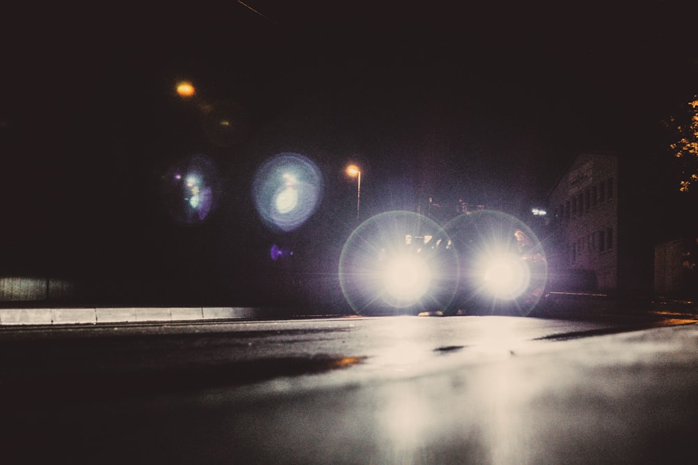 a car driving down a street at night