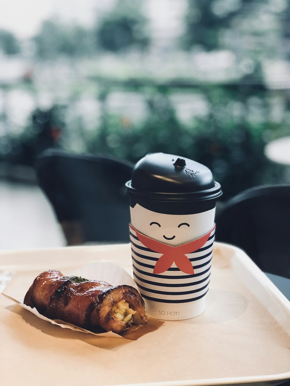 selective focus photography of food beside white disposable cup