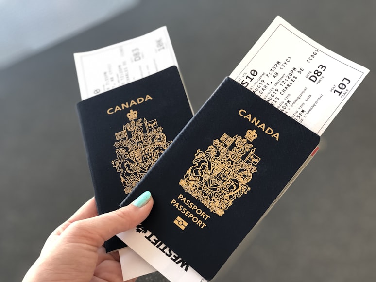 Person holding two Canadian passports