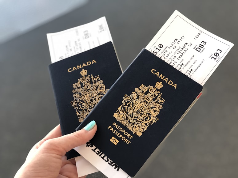 An image of a woman holding two Canadian passports