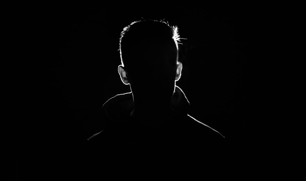 a silhouette of a man in the dark