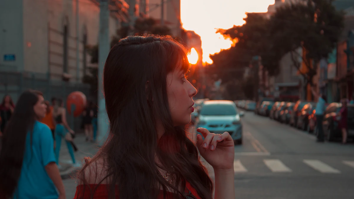 Woman drinking a cold drink on a city street at sunset