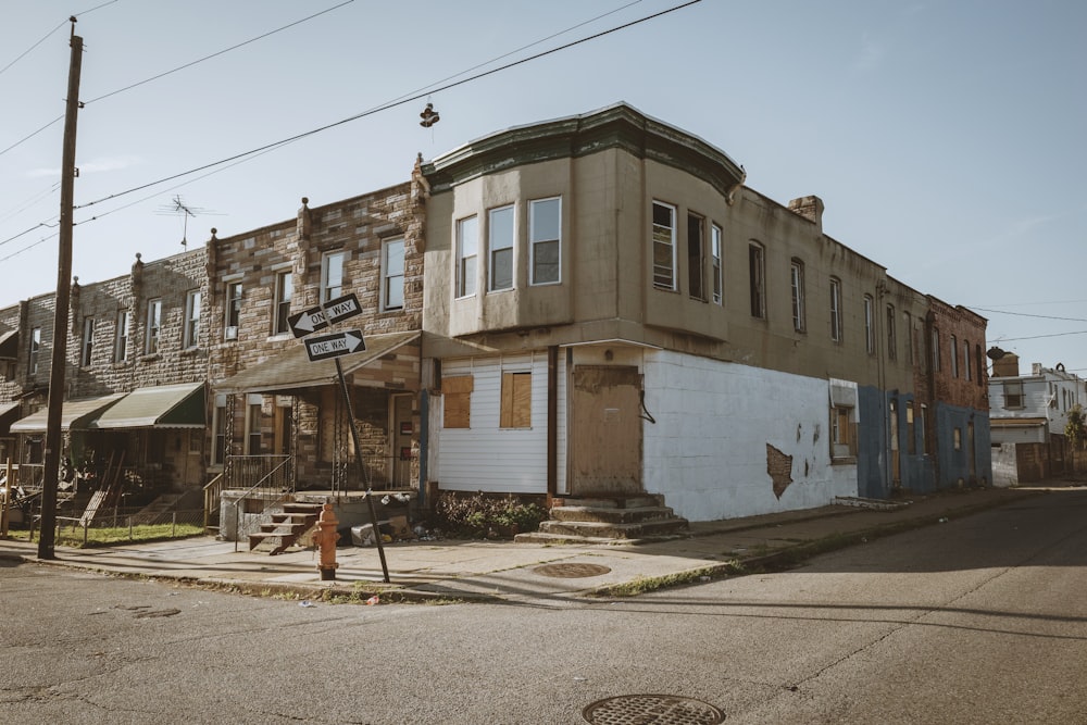 an old run down building on the corner of a street