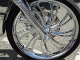 Close-up of a sleek motorcycle wheel against a clean white backdrop.