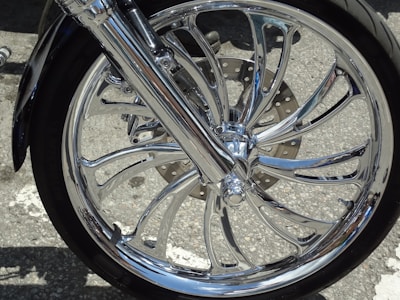 Close-up of a sleek motorcycle wheel against a clean white backdrop.