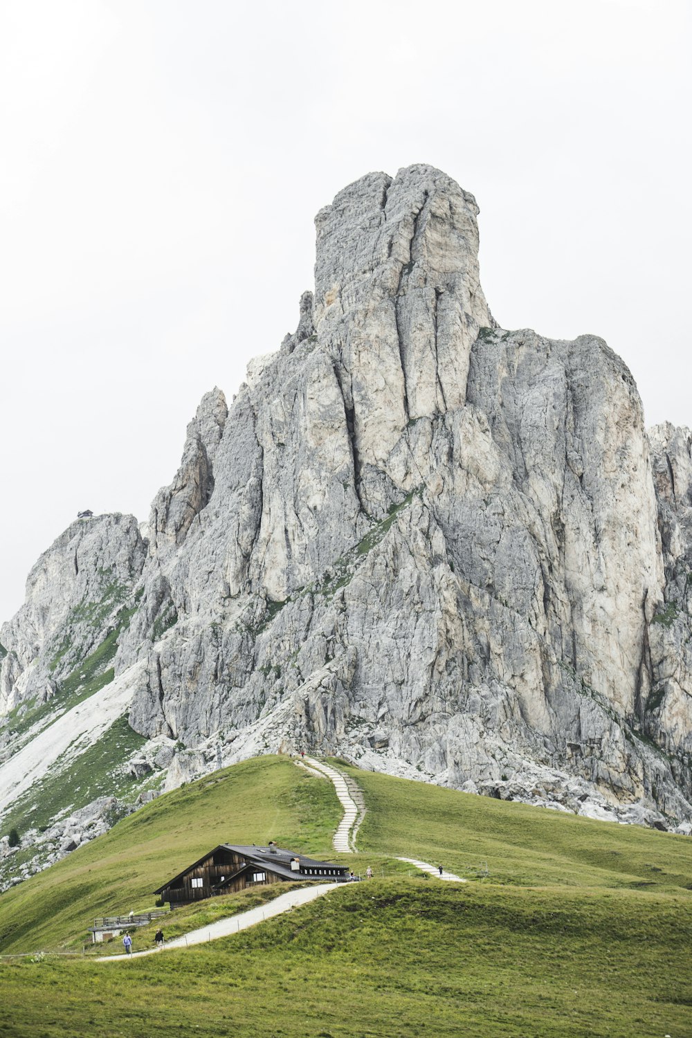 black house beside road near mountain