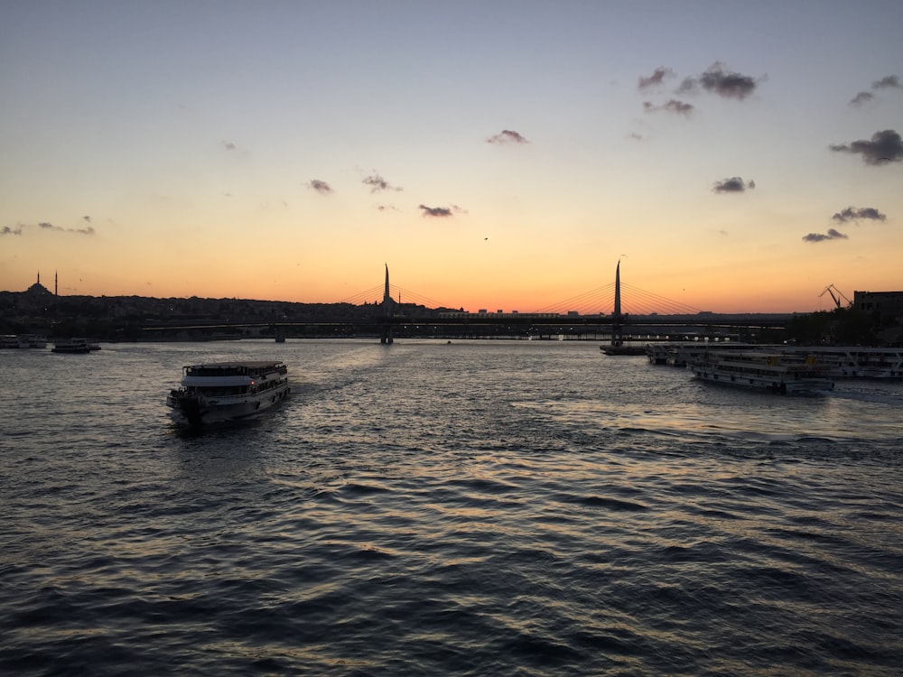 a boat traveling down a river at sunset