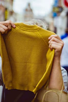 person holding sweatshirt