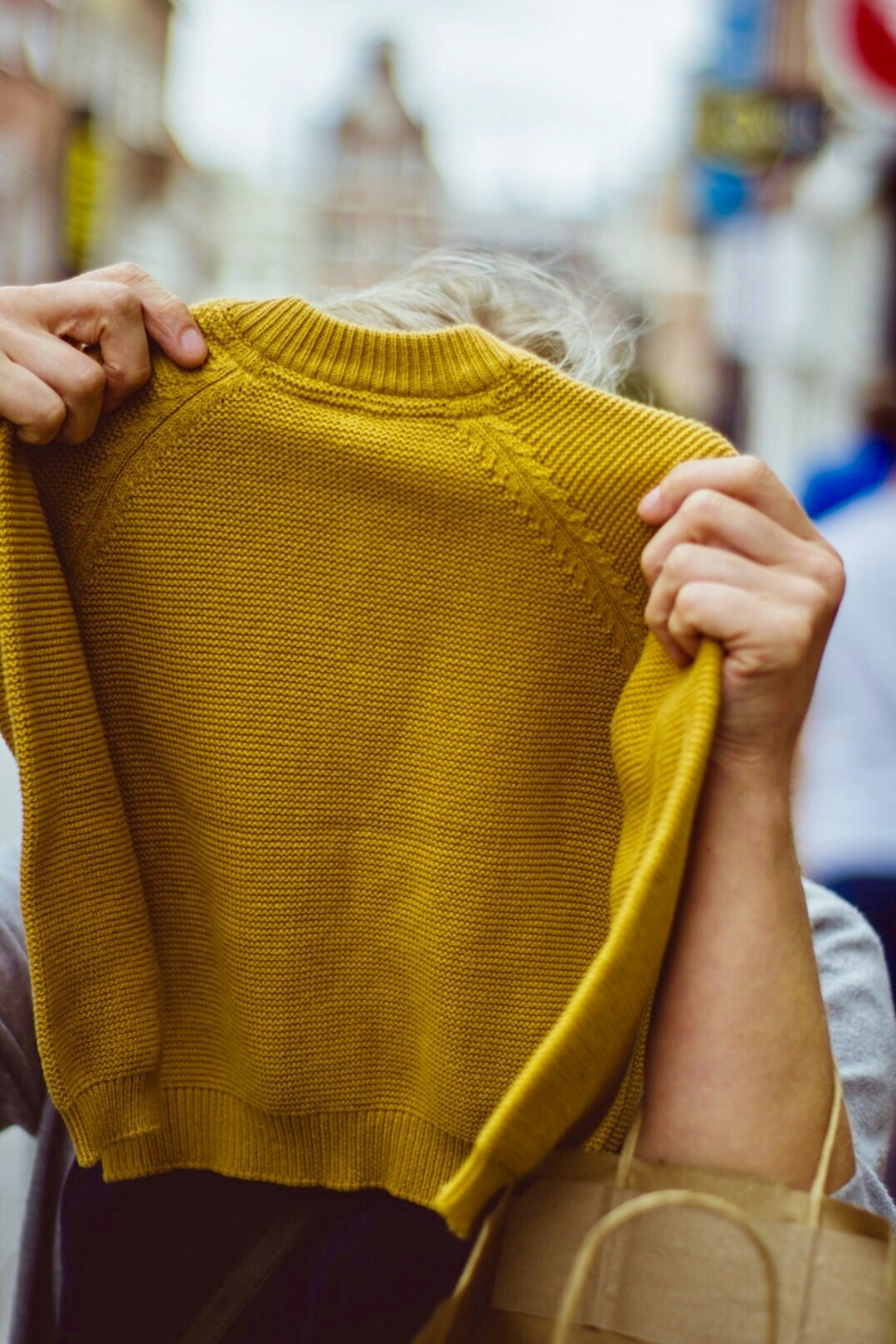 person holding sweatshirt