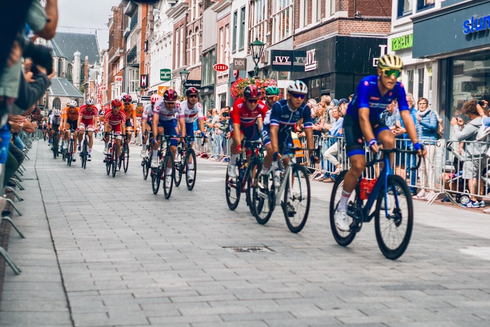 men riding bicycle doing racing during daytime