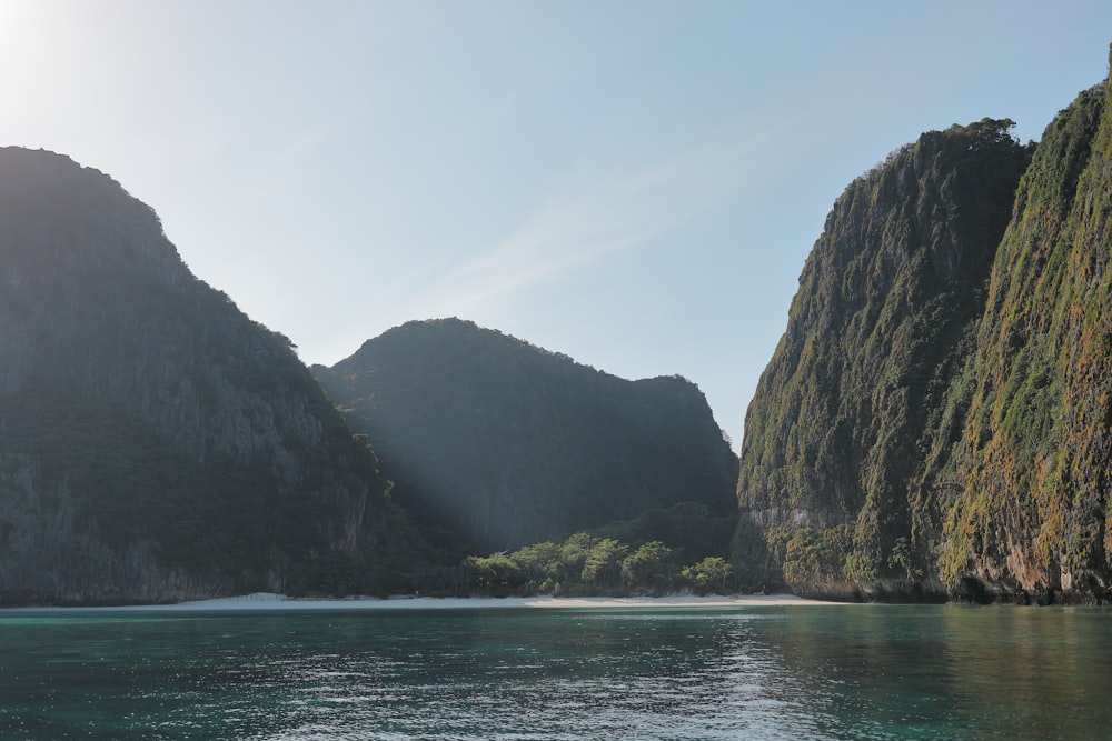 brown cliff beside body of water