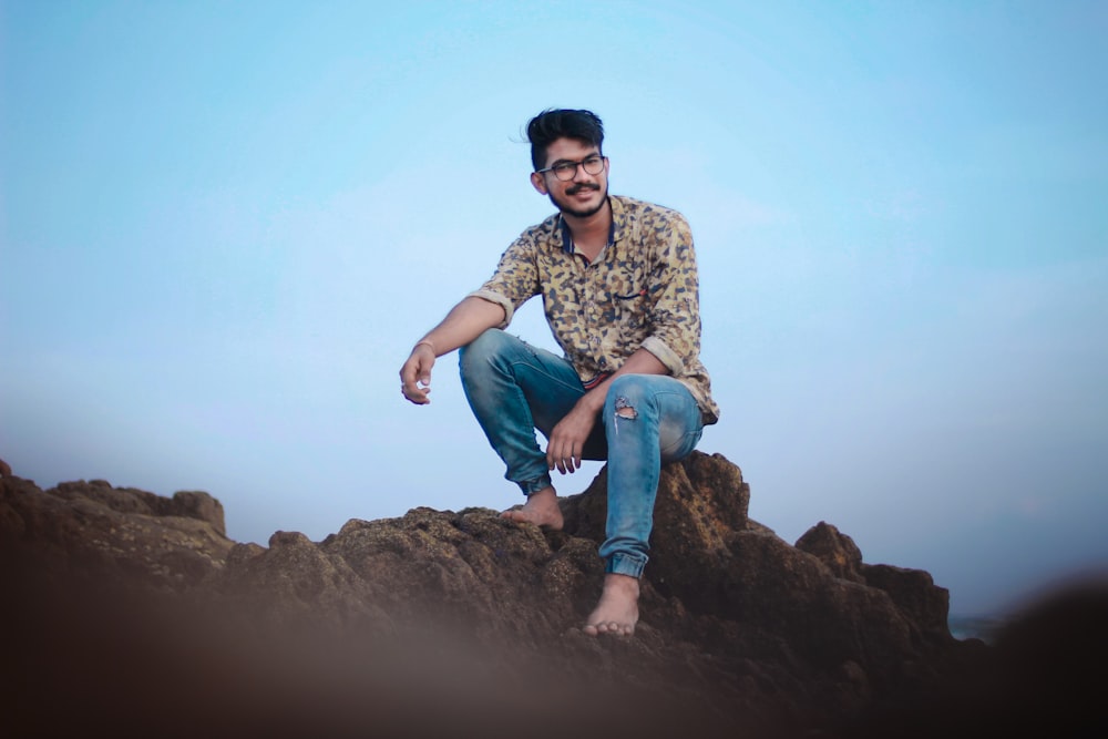 man sitting on rock