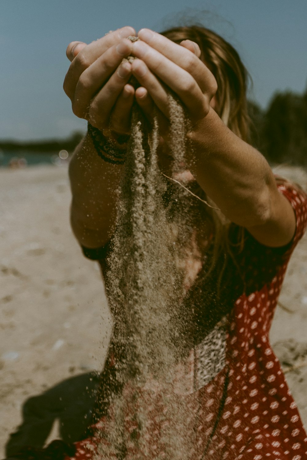 woman holding brown sand