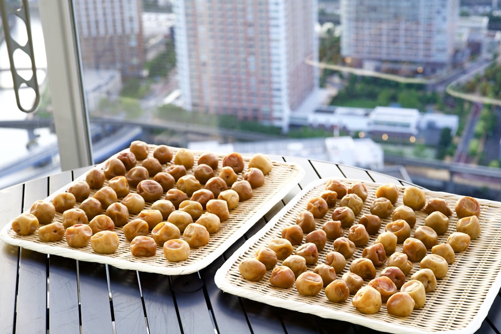 a couple of trays of food sitting on top of a table