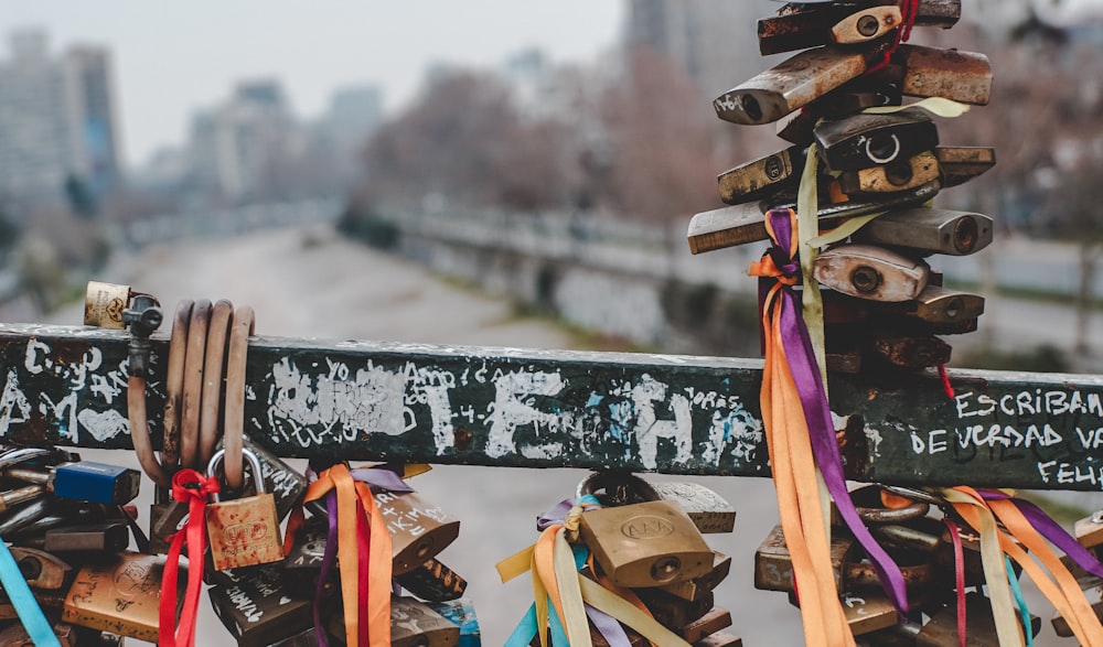 a bunch of locks are attached to a fence