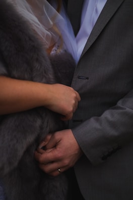 Close-up of a happy couple holding hands in a cozy setting.
